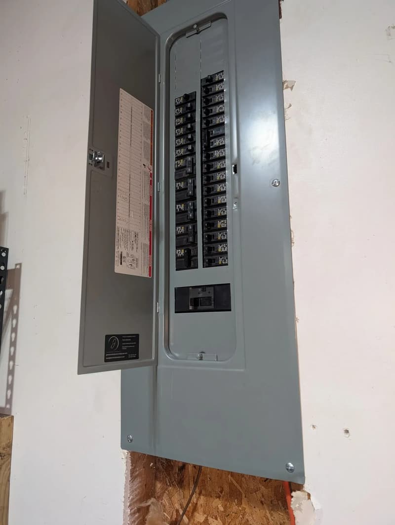 Breaker panel mounted on wall, door open