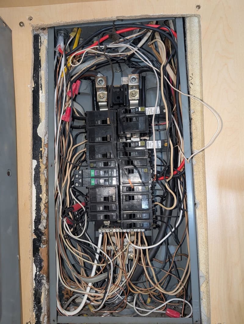 Open breaker panel with existing wiring